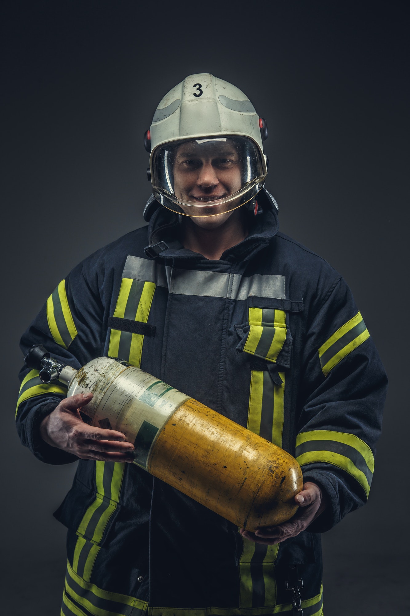 firefighter-rescue-holds-yellow-oxygen-tank-.jpg